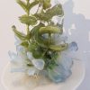 this small wall-hanging sculpture features vintage silk flowers dipped in resin and adhered to a rounded